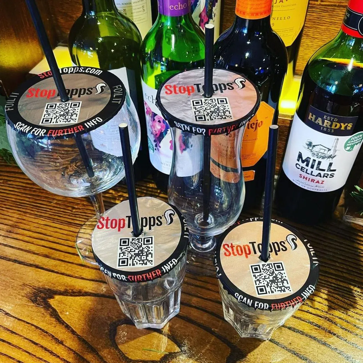 Several drinks fitted with StopTopps covers