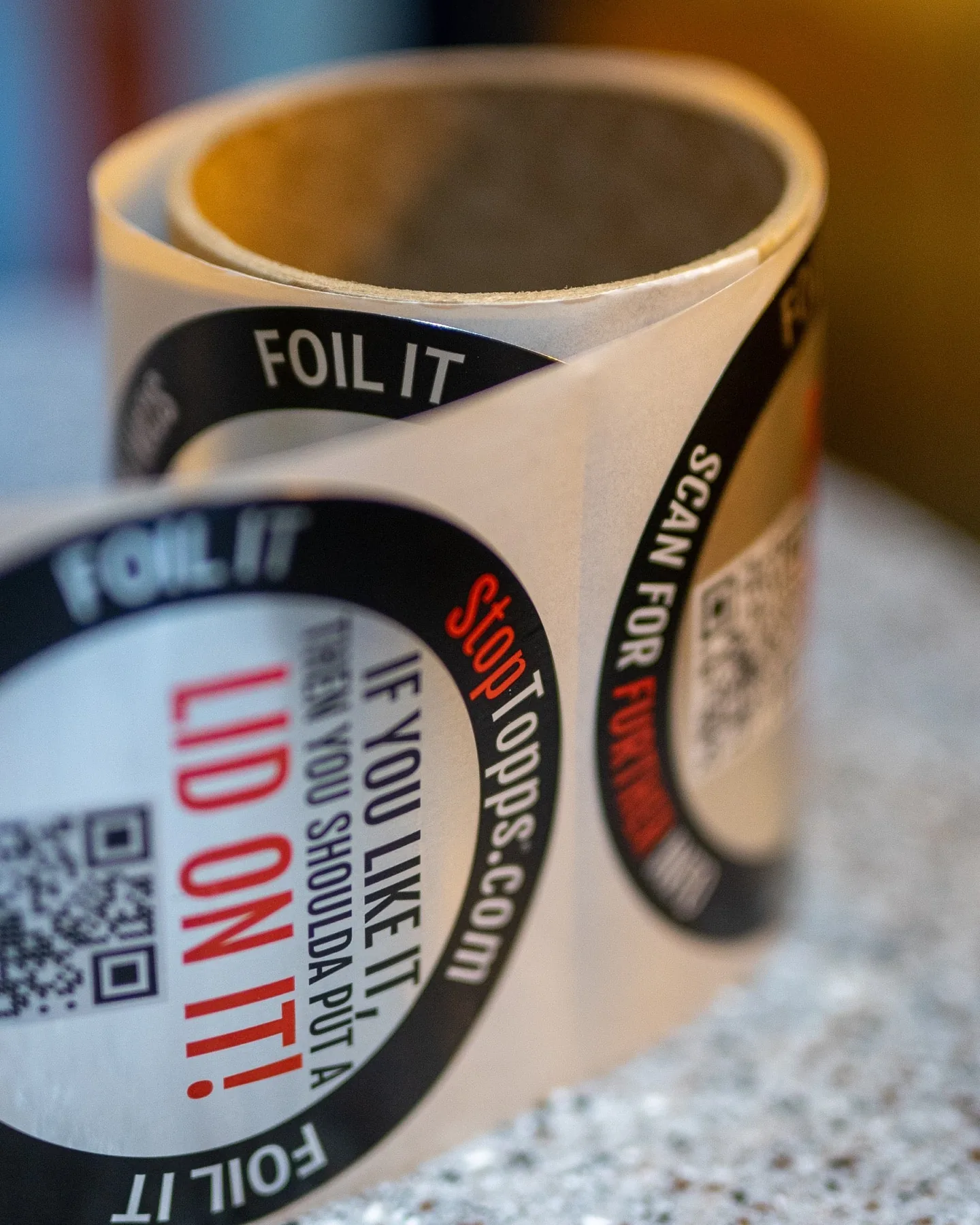 Two drinks protected with StopTopps foil covers and straws